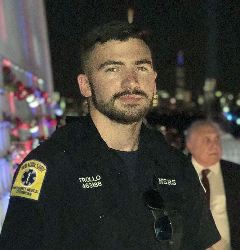 Emergency responder in uniform at night event.