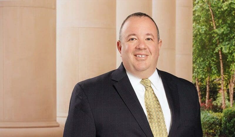 Business professional in suit smiling indoors.