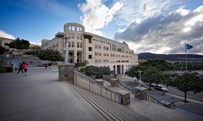 Modern building with stairs and cloudy sky.