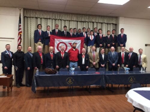 Group photo at a formal event with fraternity members.