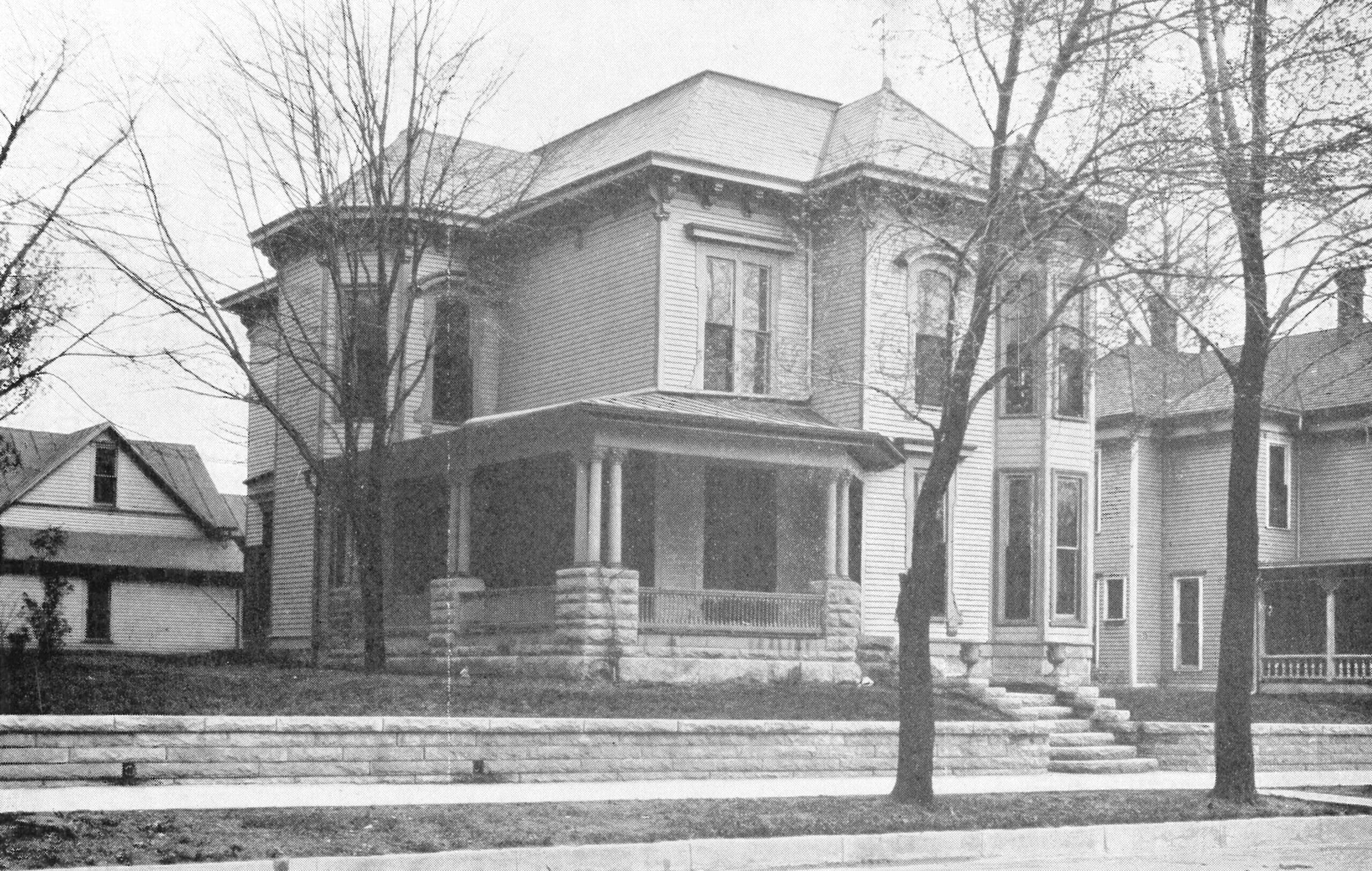 Alpha Iota - Indiana Historic Victorian-style house with porch and trees.