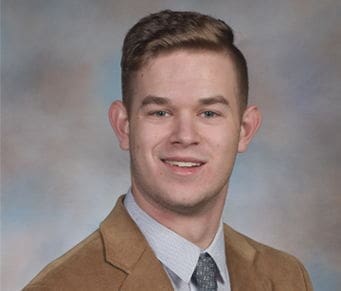 Daniel Conner Professional headshot of a young man in a suit.