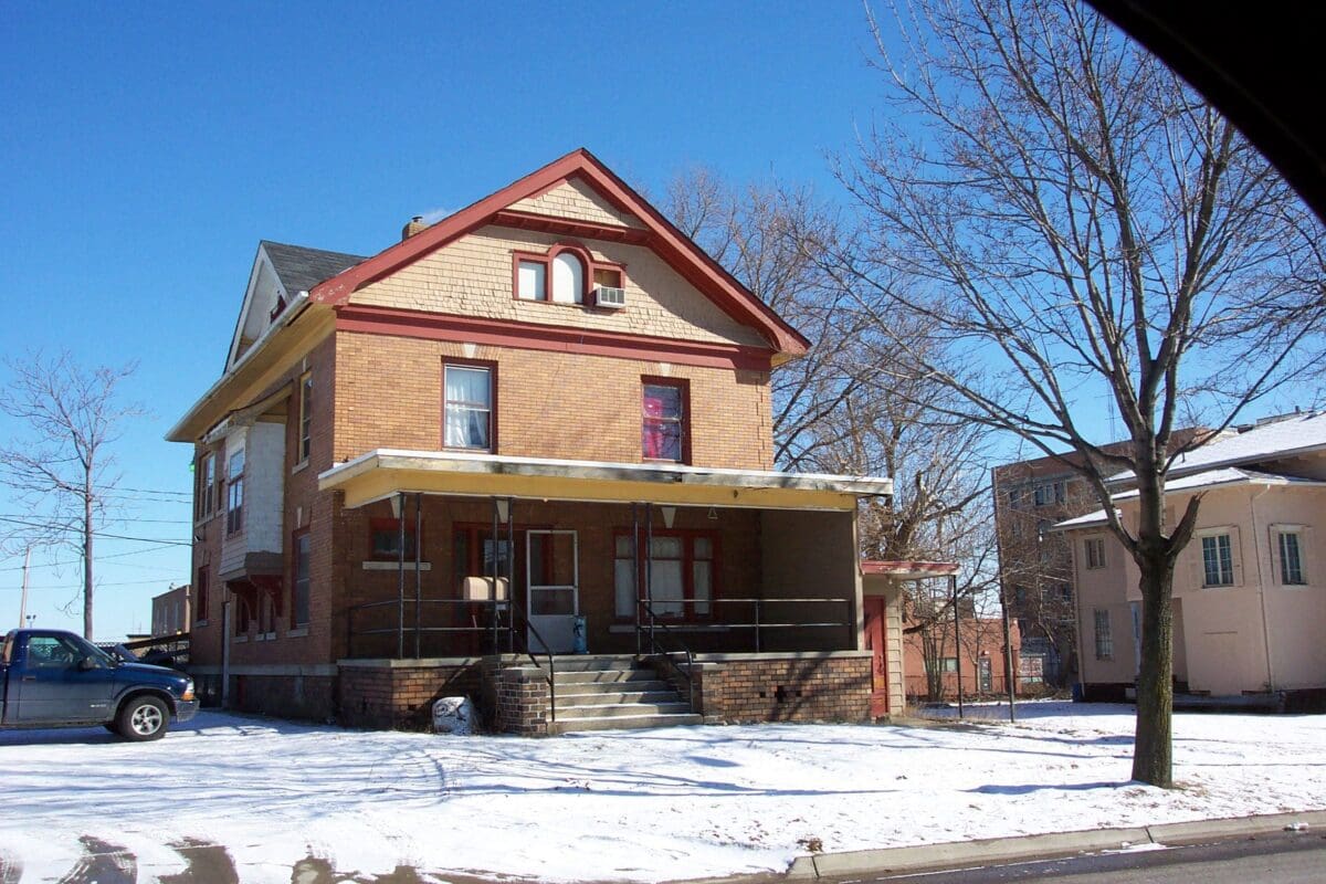 Historic brick house with snowy surroundings.