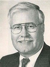 Smiling man in glasses with light-colored hair.