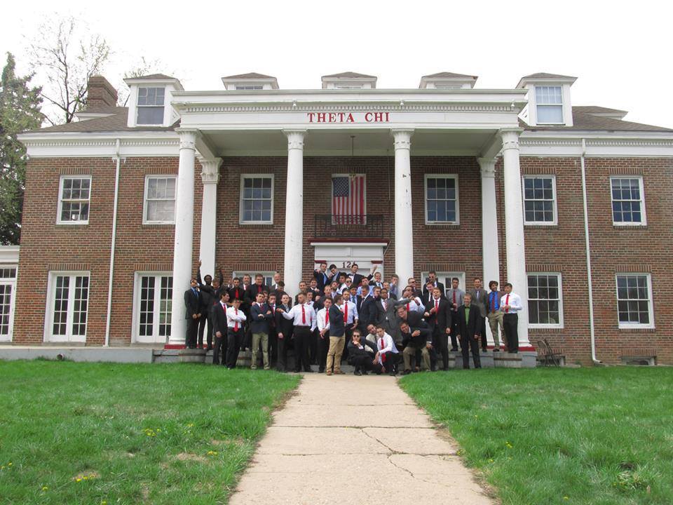 Theta Chi fraternity group photo in front of house.