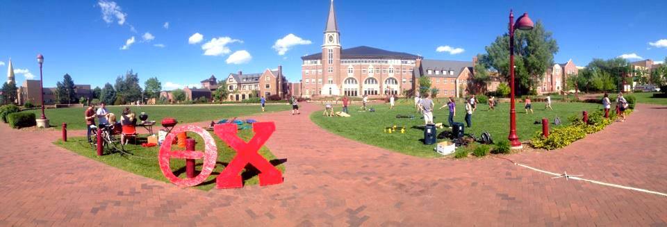 Campus event with students and large decorative letters.