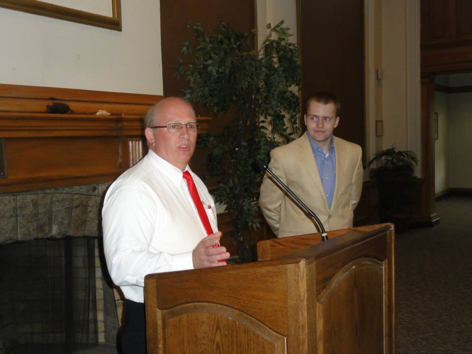 Two men speaking at a podium event.