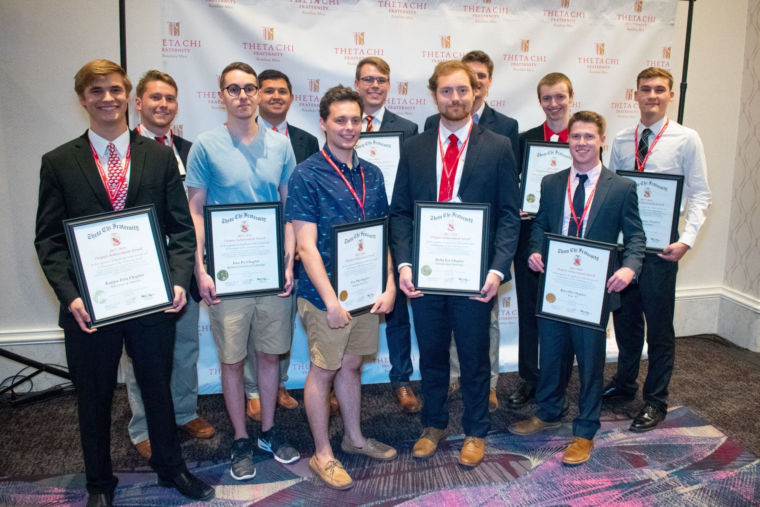 Group of award recipients at a formal event.