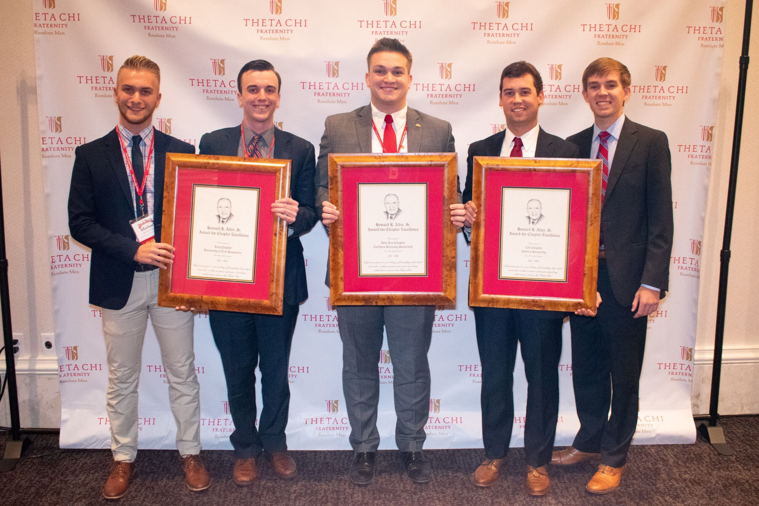 Theta Chi fraternity members with chapter excellence awards.