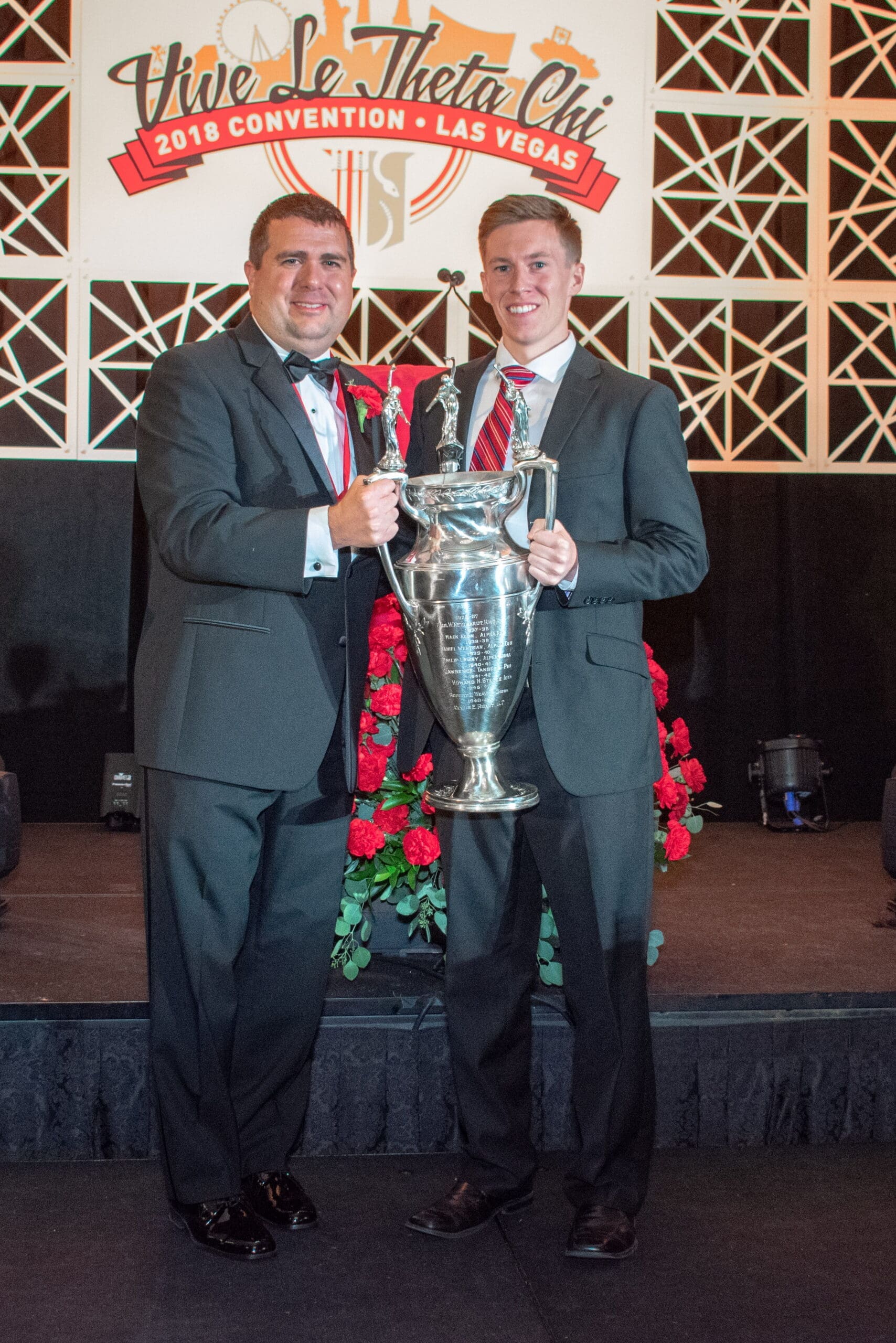 2018 Colley Award - Brandon McCoy Two men holding a trophy at an awards ceremony.