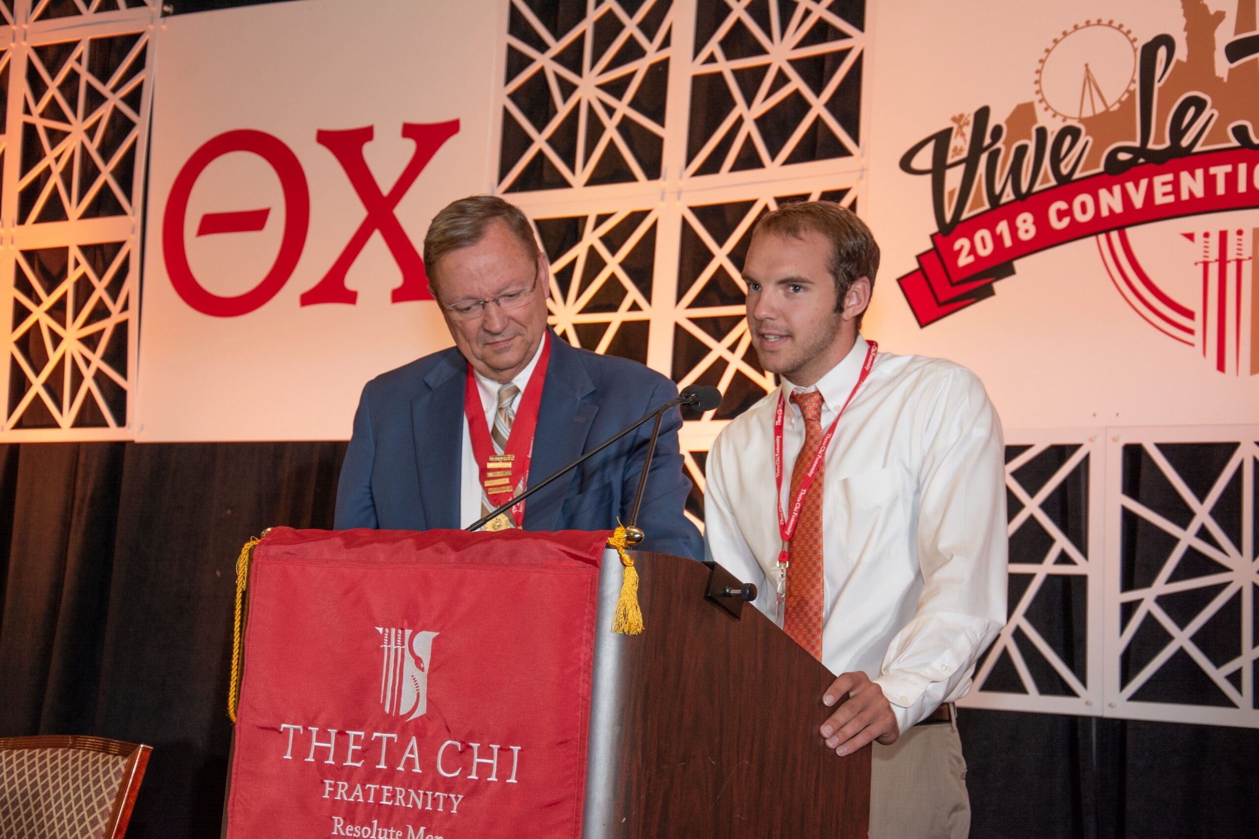 Theta Chi fraternity event with speakers at podium.