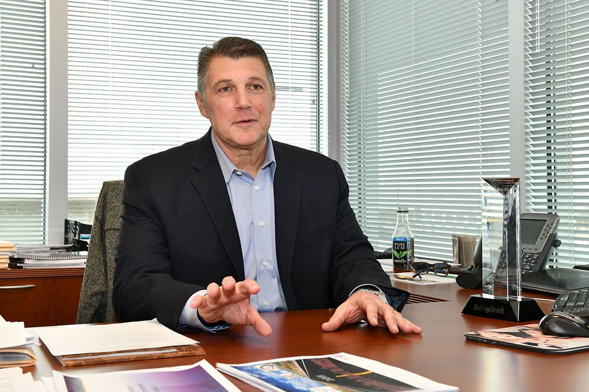 Business professional discussing ideas at office desk.