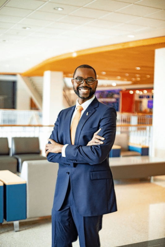 Smiling professional man in business attire indoors.