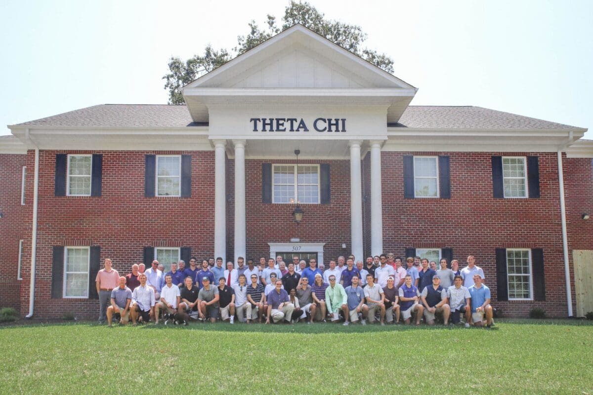 Theta Chi fraternity group photo in front of house.