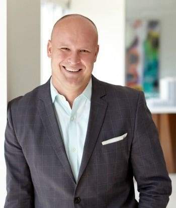 Smiling businessman in a professional suit.