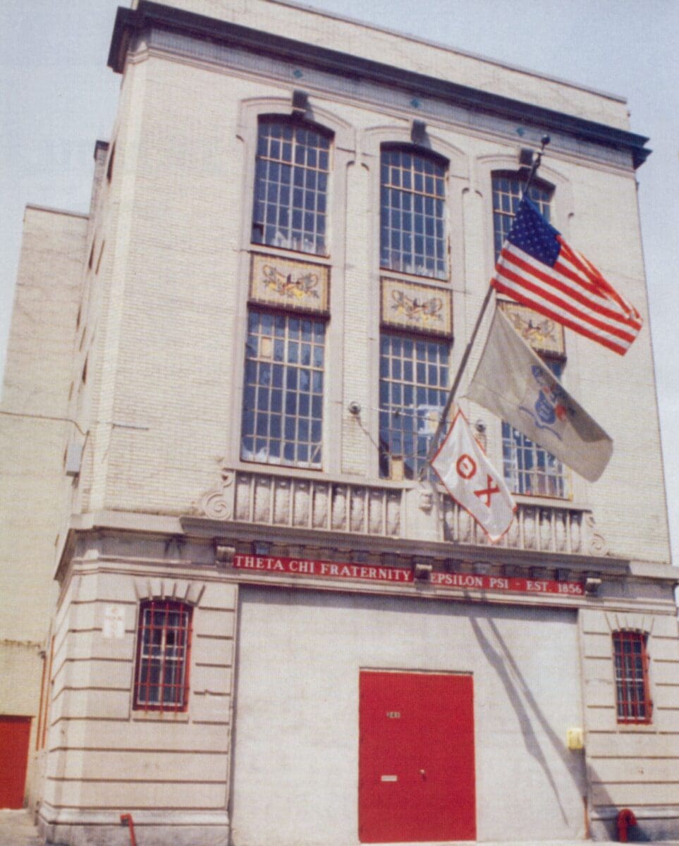 Historic fraternity building with flags flying.
