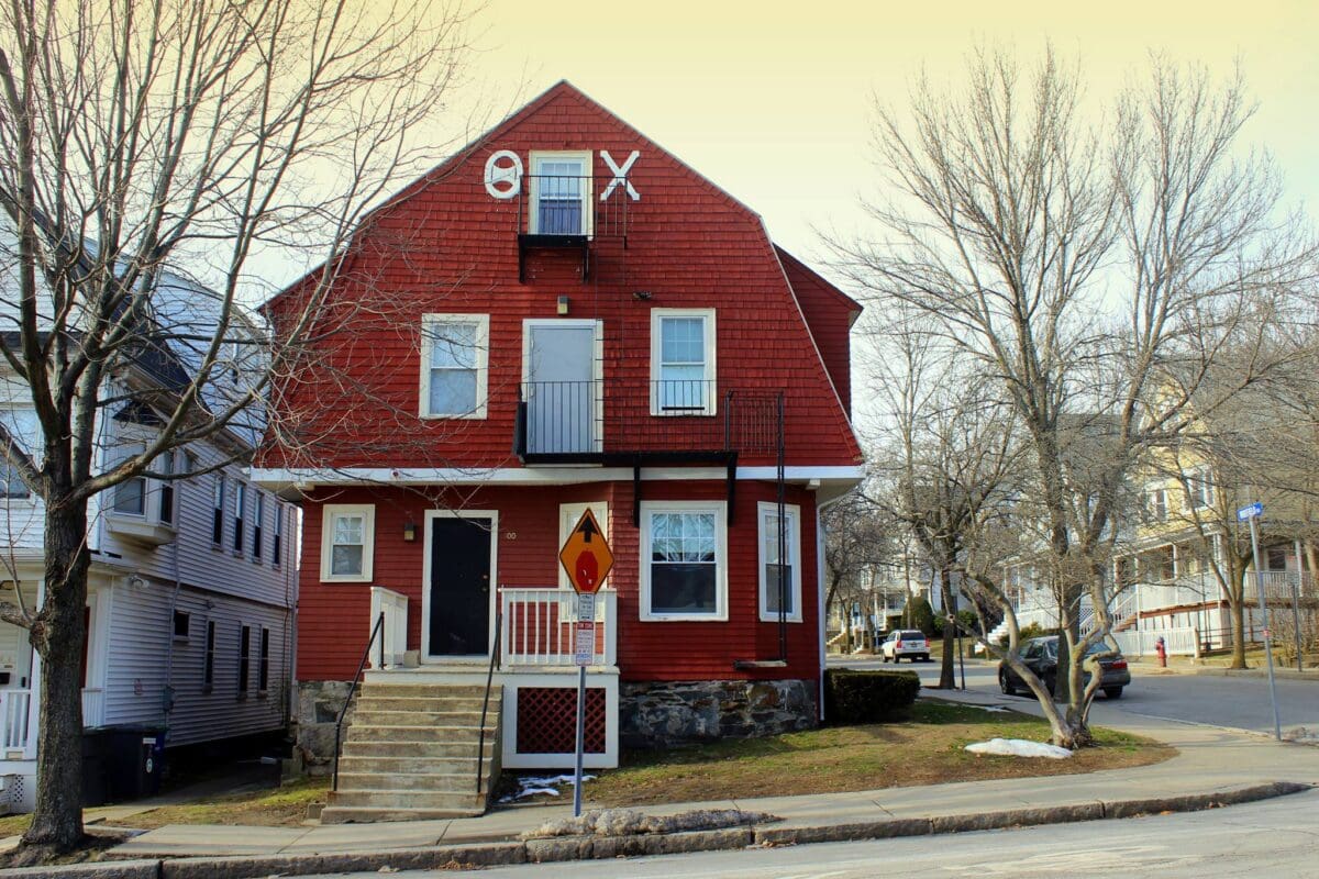 Red multi-story house with unique architectural features.