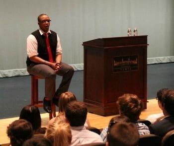 Speaker presenting to an audience at an event.