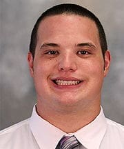 Smiling man in a professional shirt and tie.