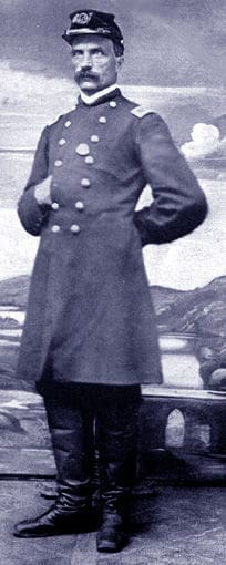 Civil War soldier in historical uniform, standing proudly.