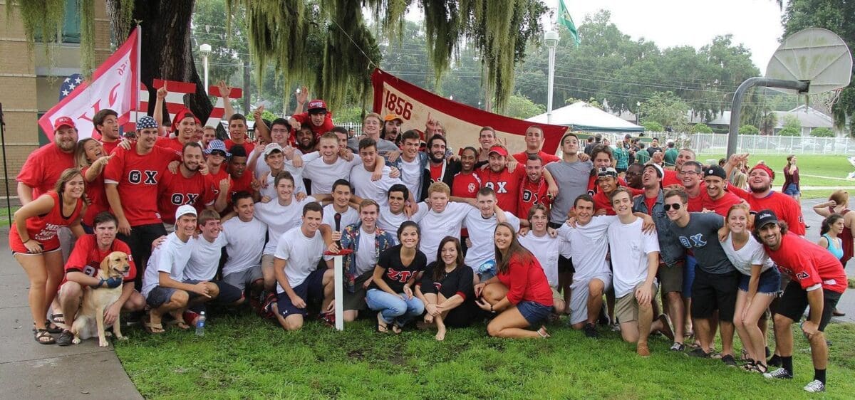 Group photo at a college event with banners.