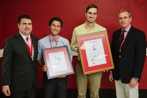 Award recipients holding framed certificates at ceremony.