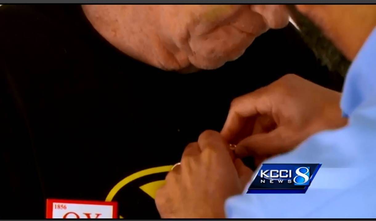 Person attaching a pin to a shirt.