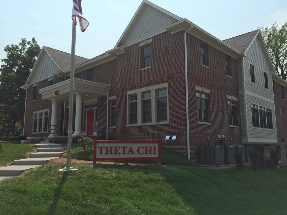 Theta Chi fraternity house exterior with American flag.