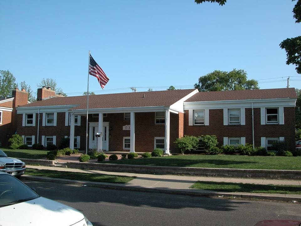 Brick apartment building with American flag.