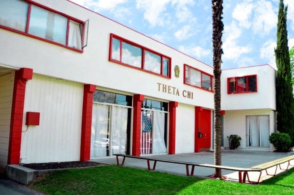 Theta Chi fraternity house exterior with American flag.