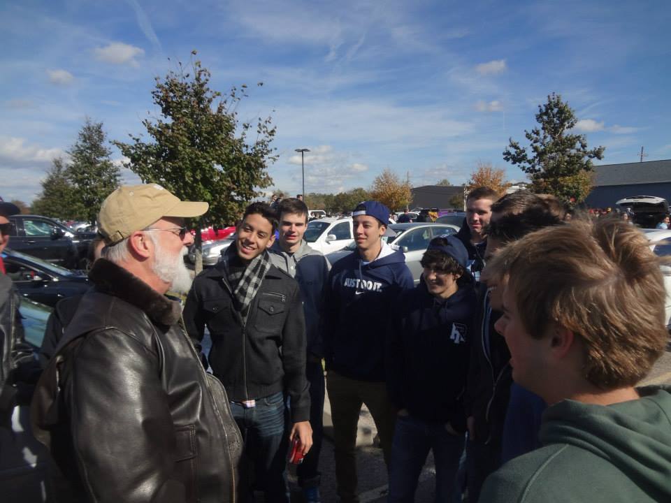 Group of people engaged in conversation outdoors.