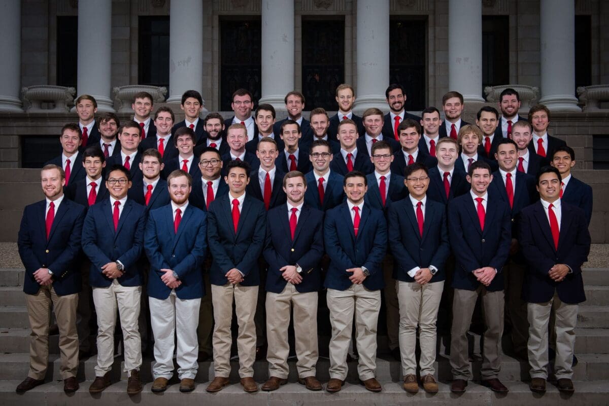 Group photo of men in suits with red ties.