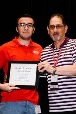 Student receiving award certificate from instructor.