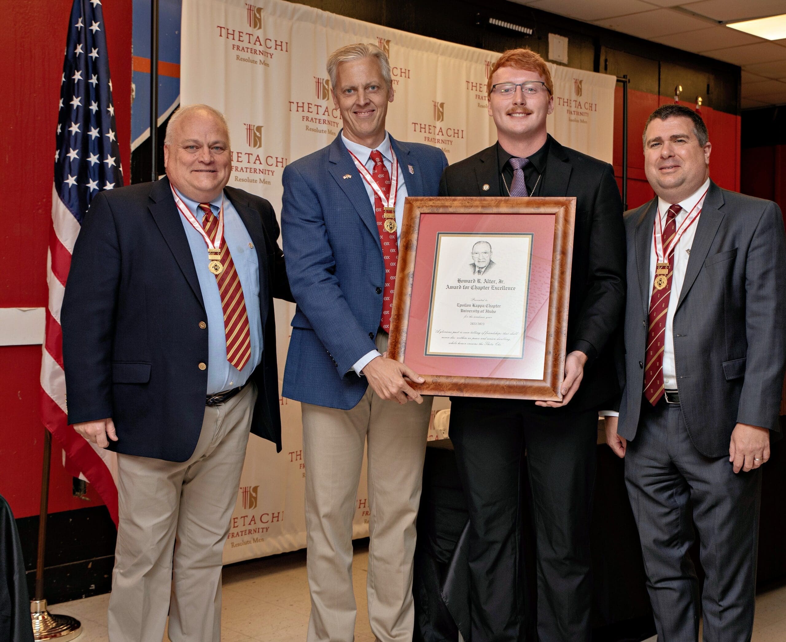 Theta Chi fraternity members receiving award for excellence.