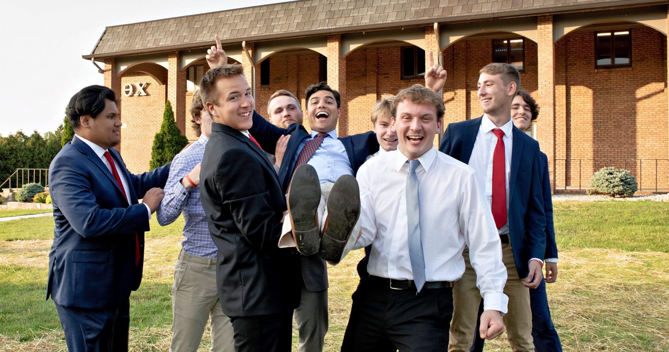 Group of friends celebrating outdoors in formal attire.
