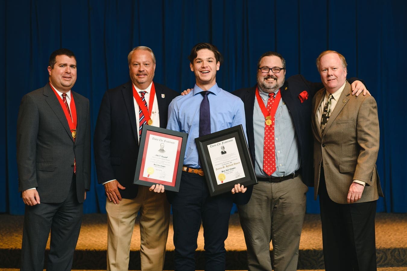 Students receiving awards at a formal ceremony.