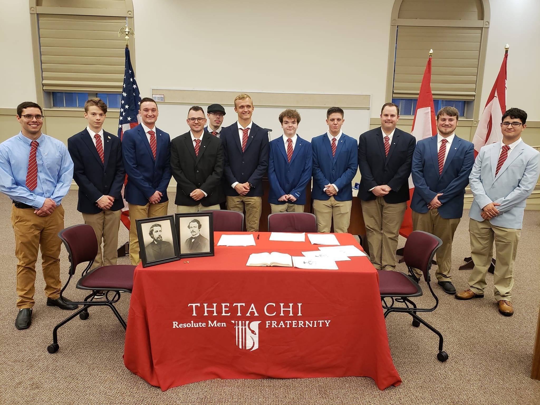 Theta Chi fraternity members at formal event gathering.