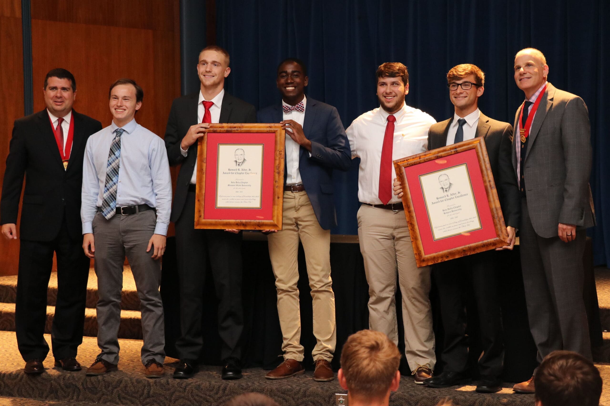 Students receiving awards at a formal event.