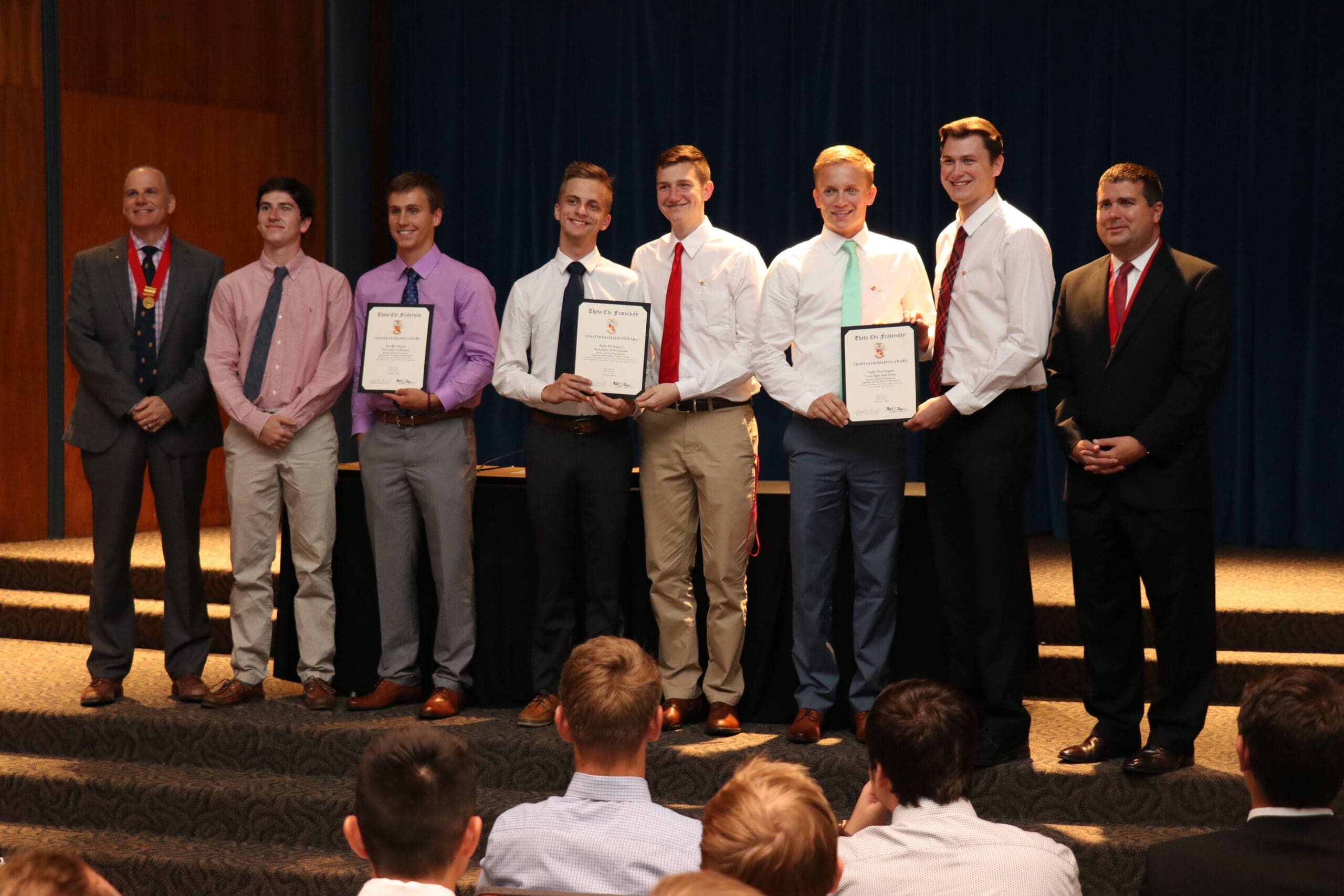Students receiving awards at a formal ceremony.