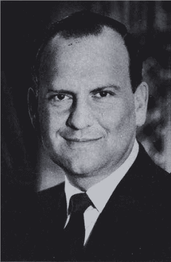 Lee Iacocca Black and white portrait of a smiling man.