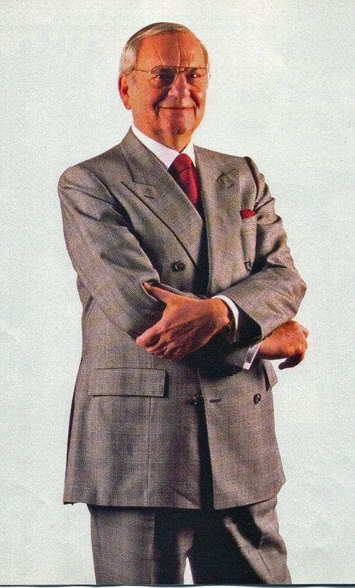 Lee Iacocca Man in gray suit with crossed arms.