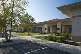 Modern commercial building with landscaped surroundings.