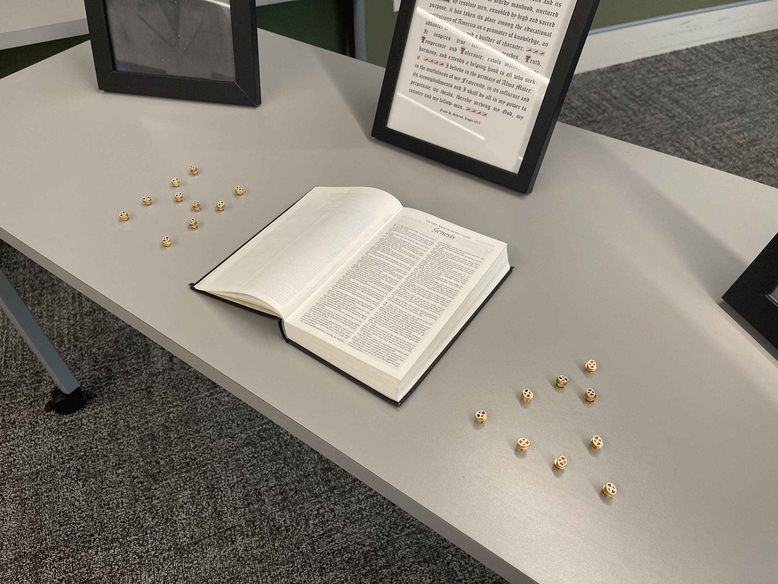 Open book with decorative items on a table.
