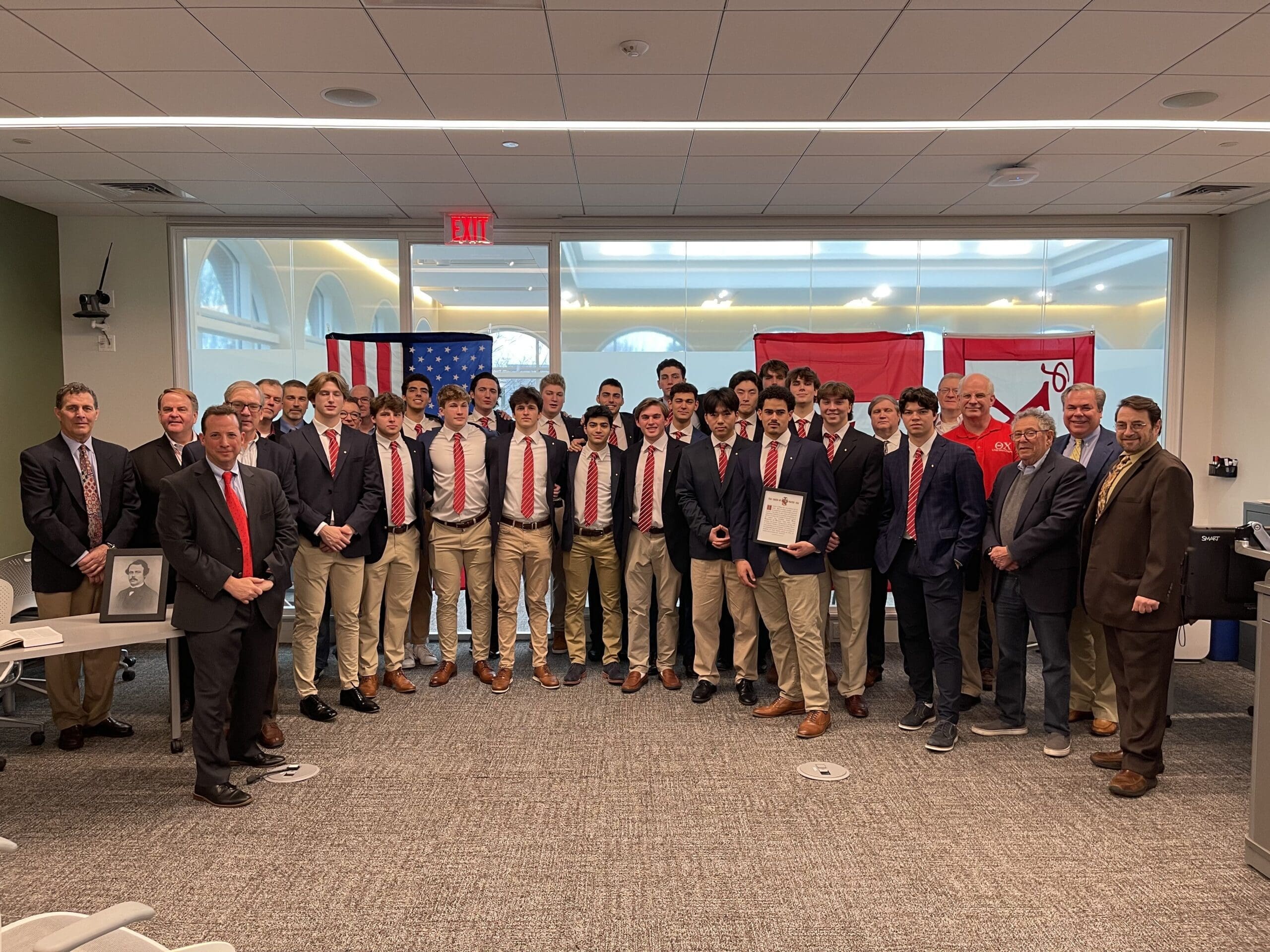 Group photo of award-winning team with flags.