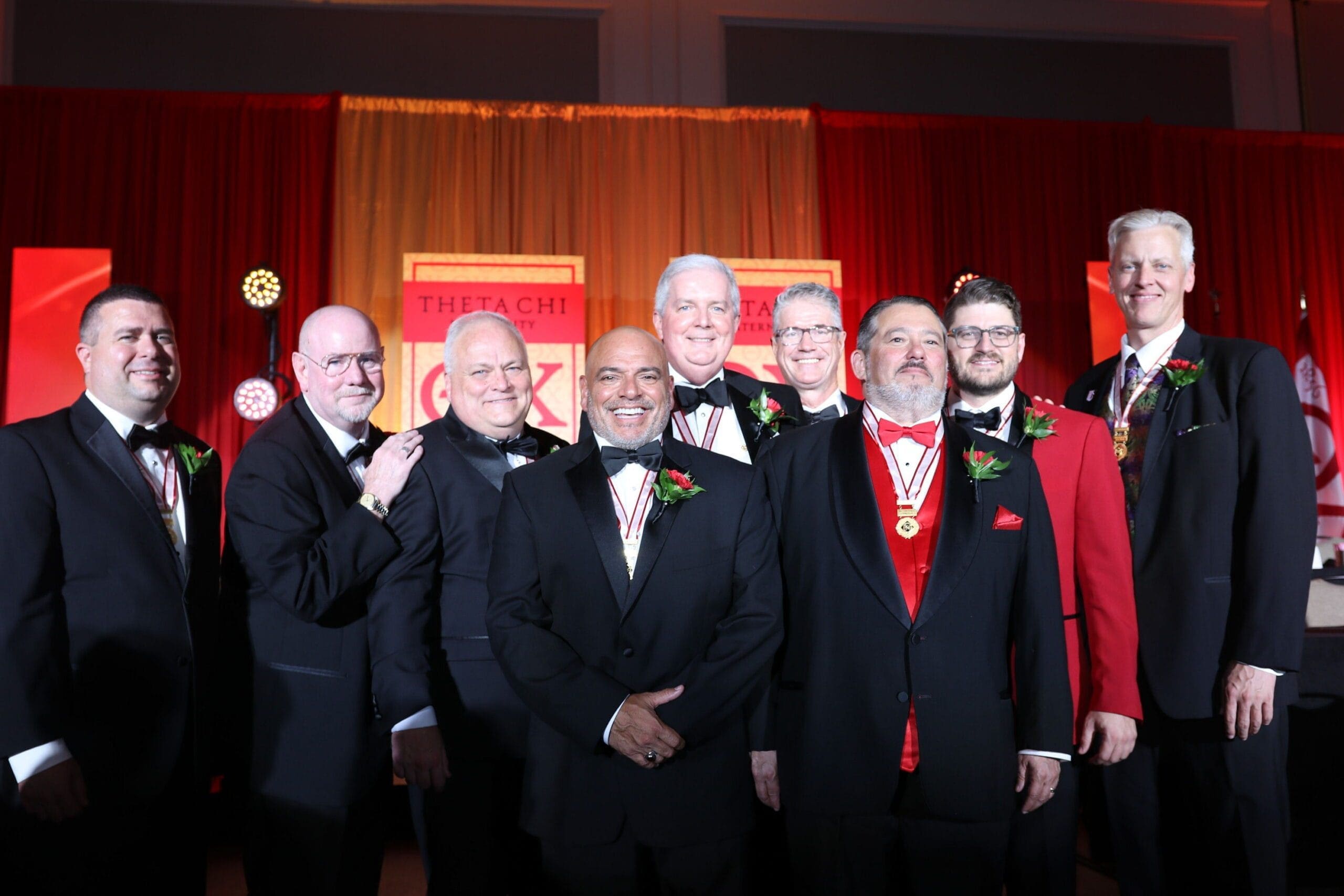 Group of men in tuxedos at formal event.
