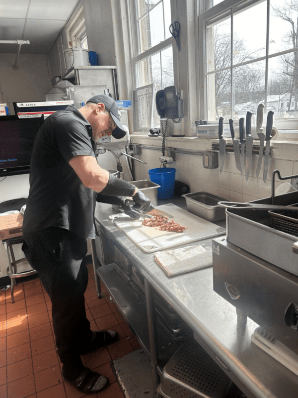 Chef preparing food in a commercial kitchen.