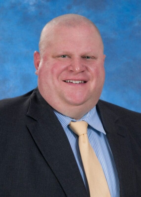 Professional man in suit with blue background.