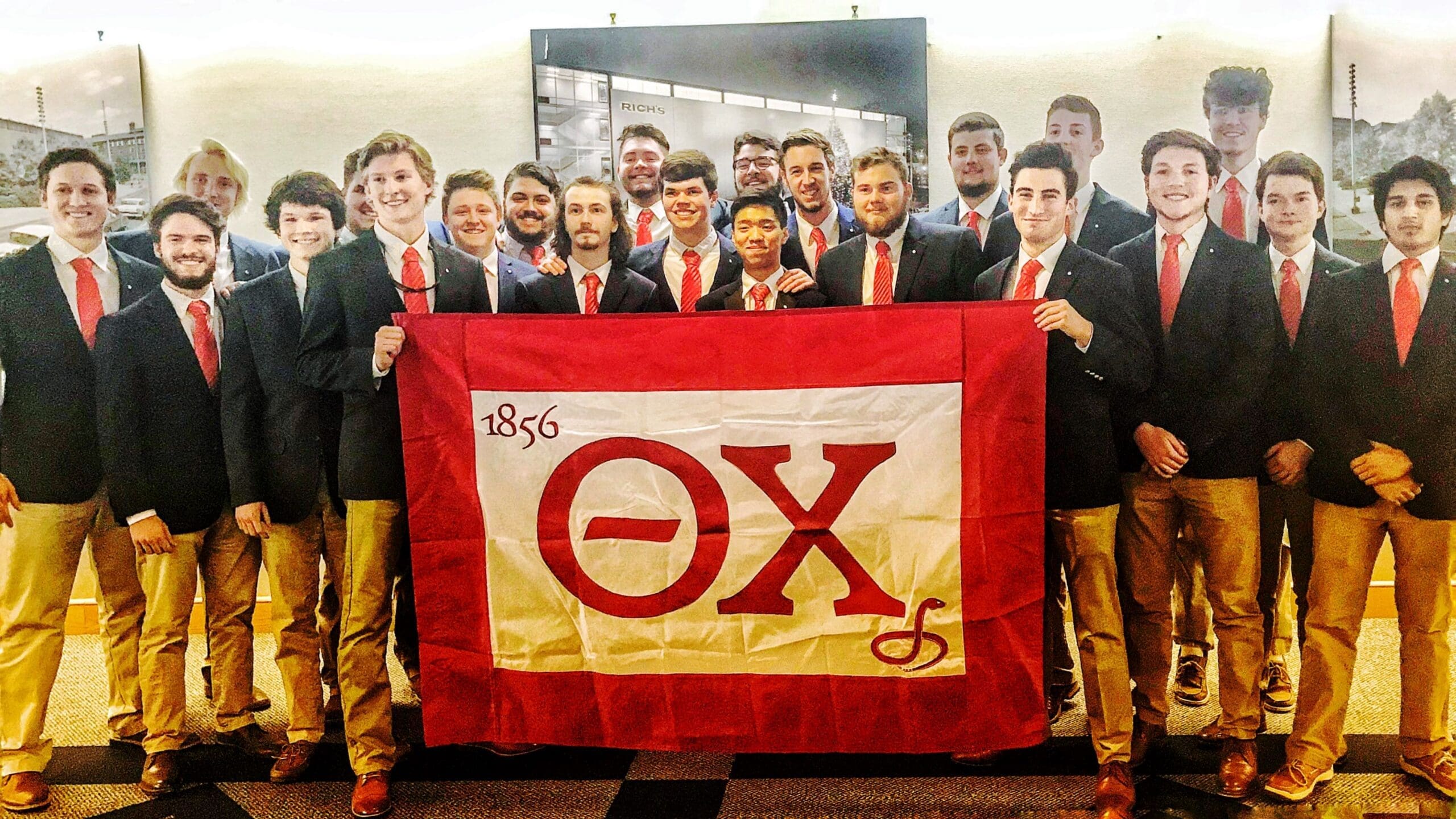 Tennessee Group of fraternity members holding a flag.