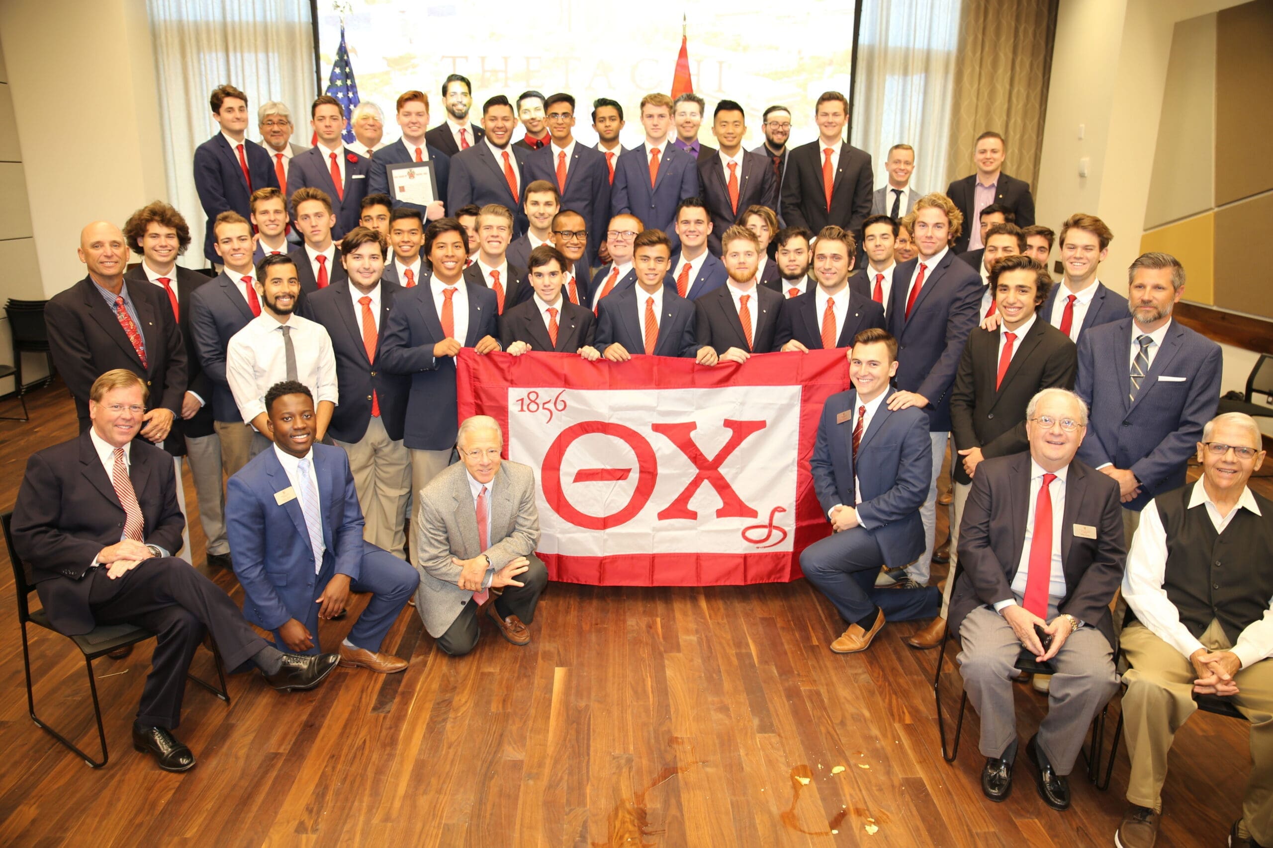 Delta Upsilon Recolonization 2018 Group photo of fraternity members with banner.