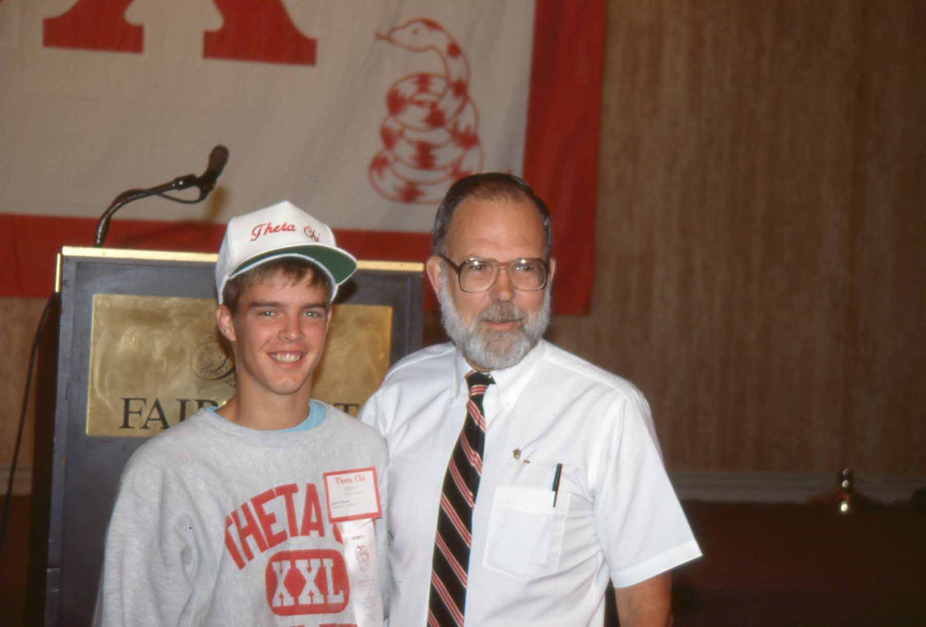 Two men posing at a conference event.